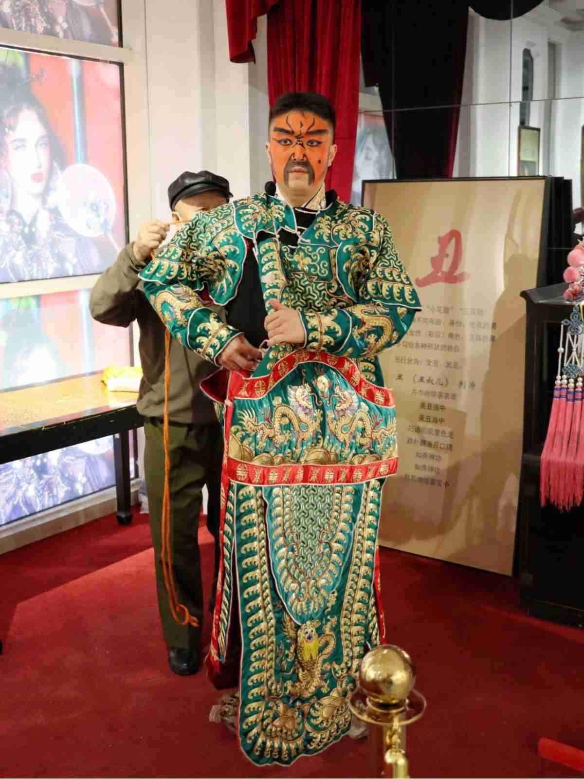 Peking opera performer getting dressed